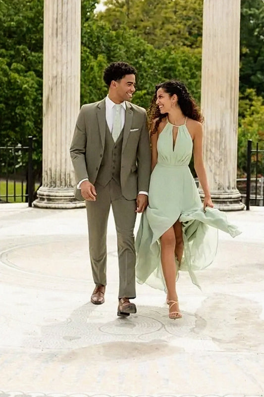 Man and woman in formal attire standing in front of classical columns
